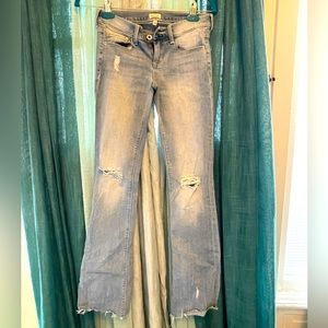 Distressed boot cut jeans in light fade